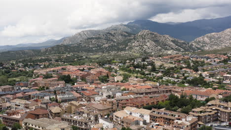 Epic-pull-out-aerial-over-the-New-Castle-of-Manzanares-El-Real-Spain-with-the-impressive-ranges-of-the-Sierra-de-Guadarrama-in-the-background