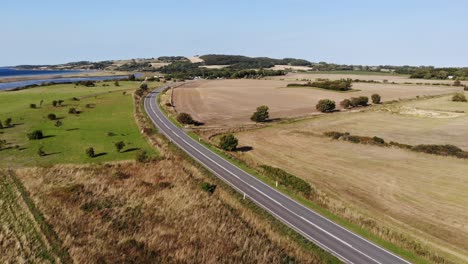 Aerial-view-of-the-coastline-of-Sejerøbugten-with-Vejrhøj,-fields-and-ocean