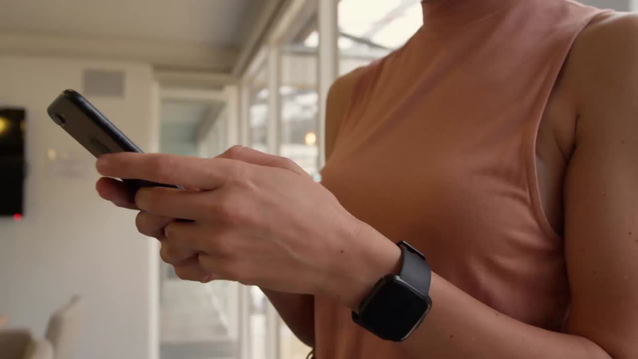 Animation of network of connection with icons over woman using smartphone