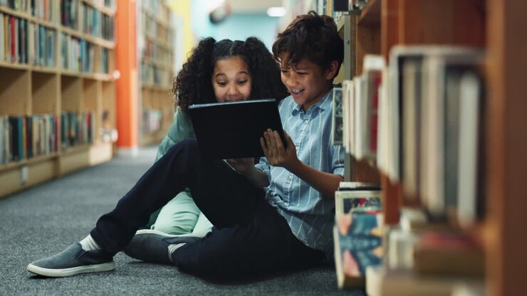 Children using a tablet in the library