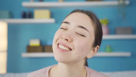 close-up portrait of thinking asian young woman daydreaming.