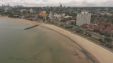 drone aertial over the beach in st kilda showing the beach, luna park and skate park