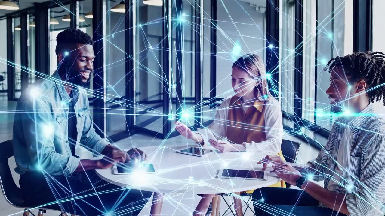 A futuristic video concept showing three people at a table with digital network overlays