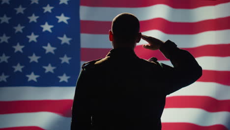 American-patriot-doing-salute-hand-gesture-towards-USA-flag