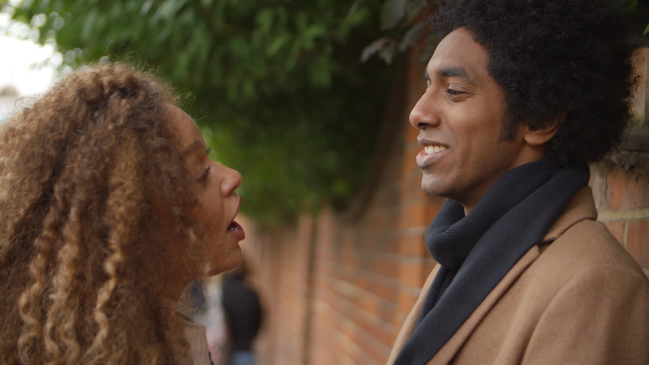 Stylish Young Couple Talking On City Street