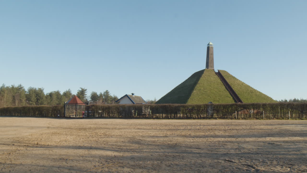 Panning past Austerlitz Pyramid - wide. The Piramide van Austerlitz is a monument in the Netherlands, built in 1804 as a tribute to Napoleon Bonaparte.