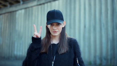 smiling girl showing peace sign