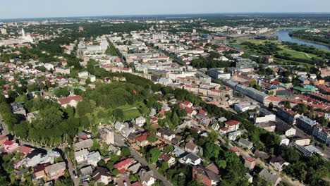 zaliakalnis private homes and downtown of kaunas city, aerial fly back view