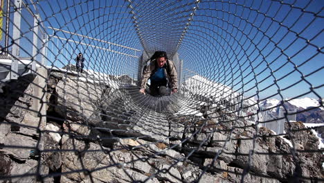 Climbing-steel-cage-tunnel-Swiss-alps-heights