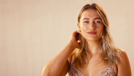 studio shot of confident natural laughing woman in underwear promoting body positivity