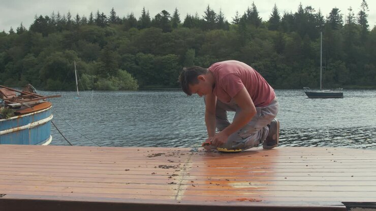 Carpenter takes a break from working on cabin roof