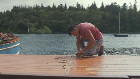 carpenter takes a break from working on cabin roof