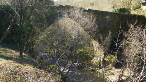 Pan-across-underside-of-old-Roman-Navea-Bridge