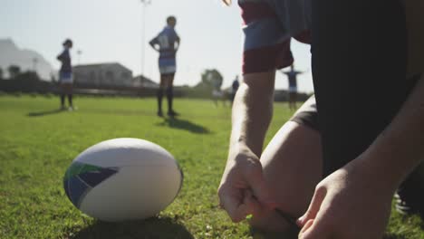 young adult female rugby player on a rugby pitch