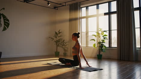 woman practicing yoga in a bright studio