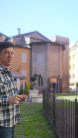 man leaning against fence in european town