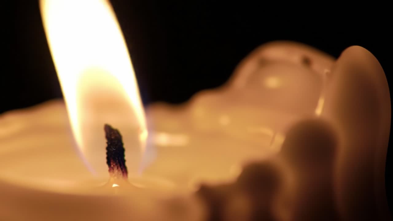 Soft candlelight dances in a quiet room, creating a serene atmosphere. The warm glow provides a comforting ambiance, inviting peaceful thoughts and relaxation.