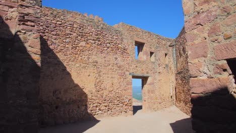 Inside-the-walls-of-the-castle-ruins-on-a-hill-in-Castellon,-Spain--Slow-pan