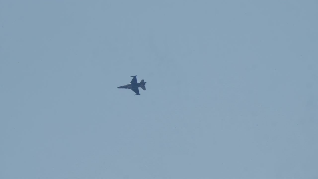 Military Fighter Jet Flying Across a Clear Blue Sky