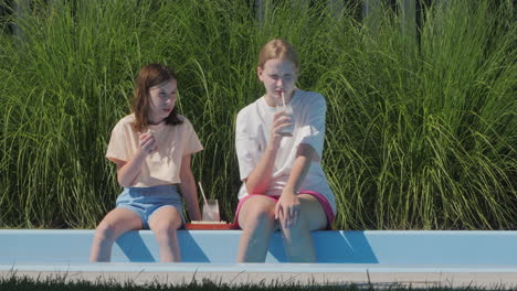 two girls enjoying a summer day at the pool