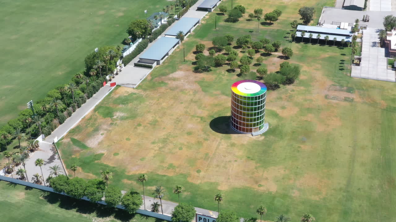 Empty and desolate Empire polo club colorful round tower building at Coachella Valley Music Arts Festival, covid-19 pandemic, above circle aerial