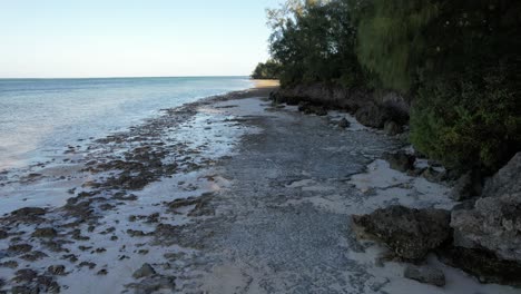 Low-tide-in-a-small-and-natural-beach-with-rocks-in-Kiwengwa,-Zanzibar