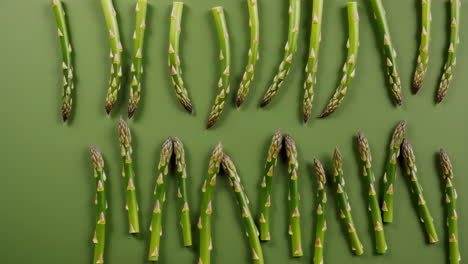 fresh asparagus spears on green background