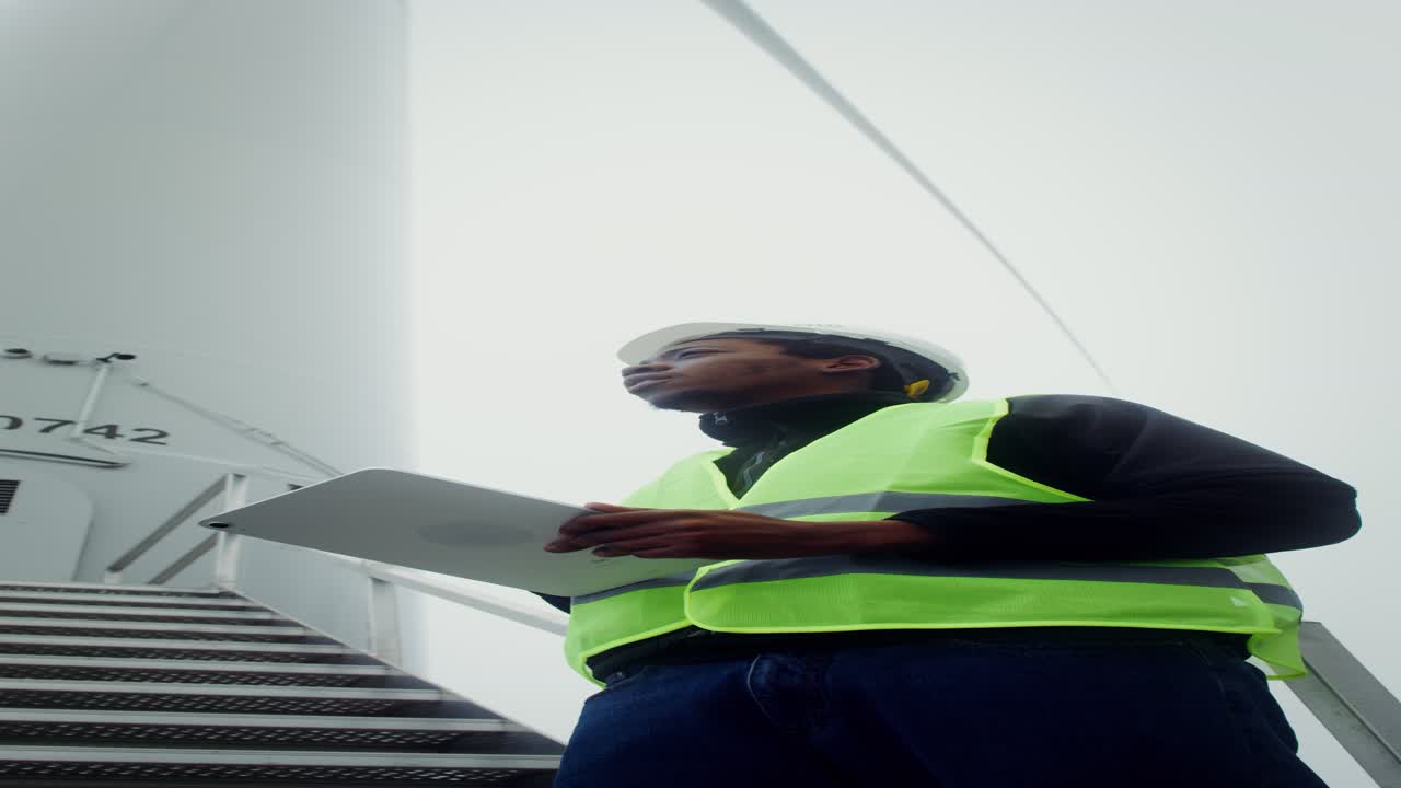 Wind Turbine Technician Inspecting