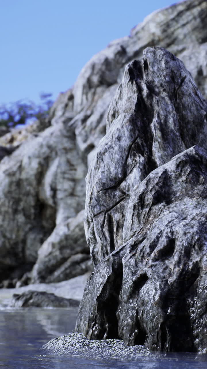 Majestic rock formation stands tall against tranquil ocean backdrop at dawn