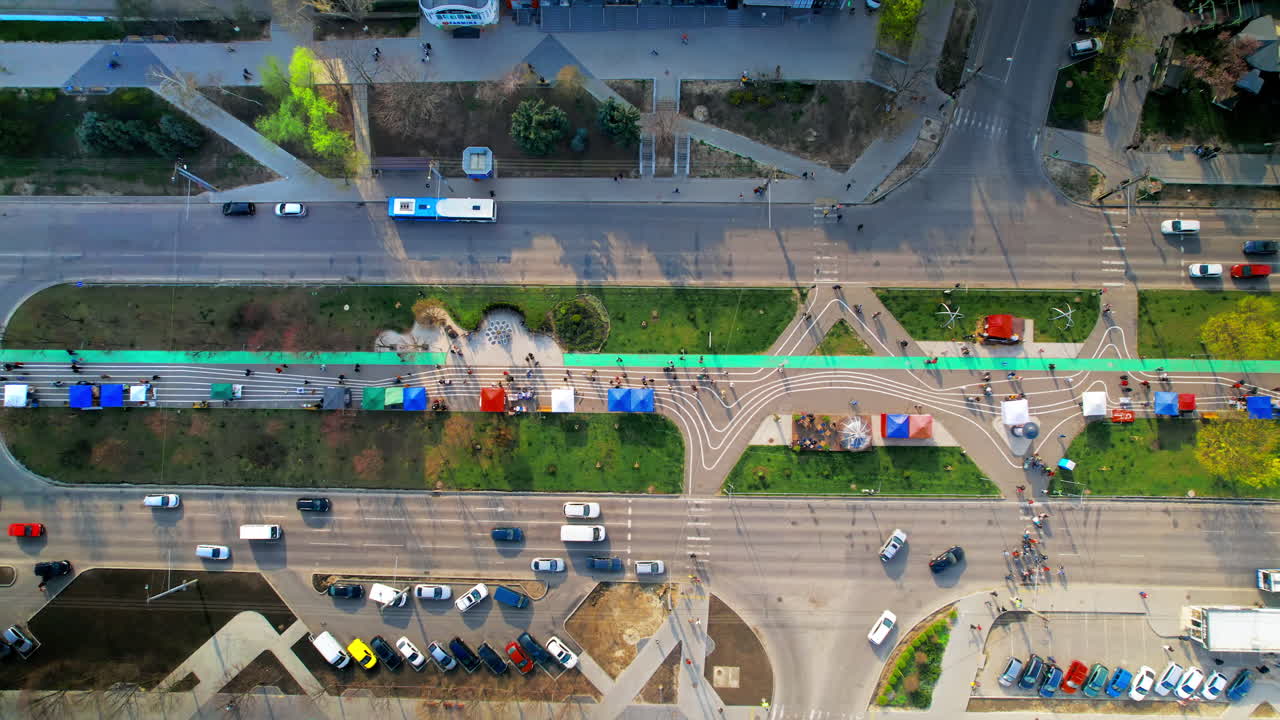 Aerial drone view of Chisinau in spring, Moldova. Residential district, alley with walking people, road with moving cars