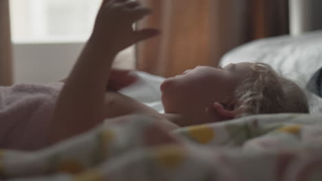 baby girl in bed after waking up