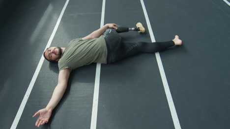 man with prosthetic leg doing post workout stretch