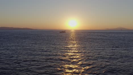 Aerial---Yacht-cruising-at-sunset