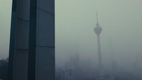 kuala lumpur city tower in fog