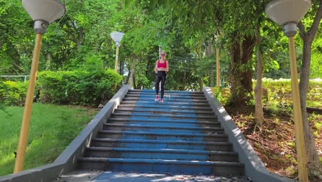woman running up stairs in a park