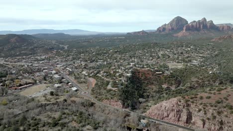 downtown sedona, arizona with drone video wide shot moving in with mountains