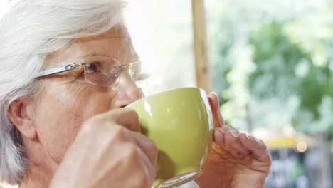 Senior-woman-having-coffee-in-the-cafe-4k