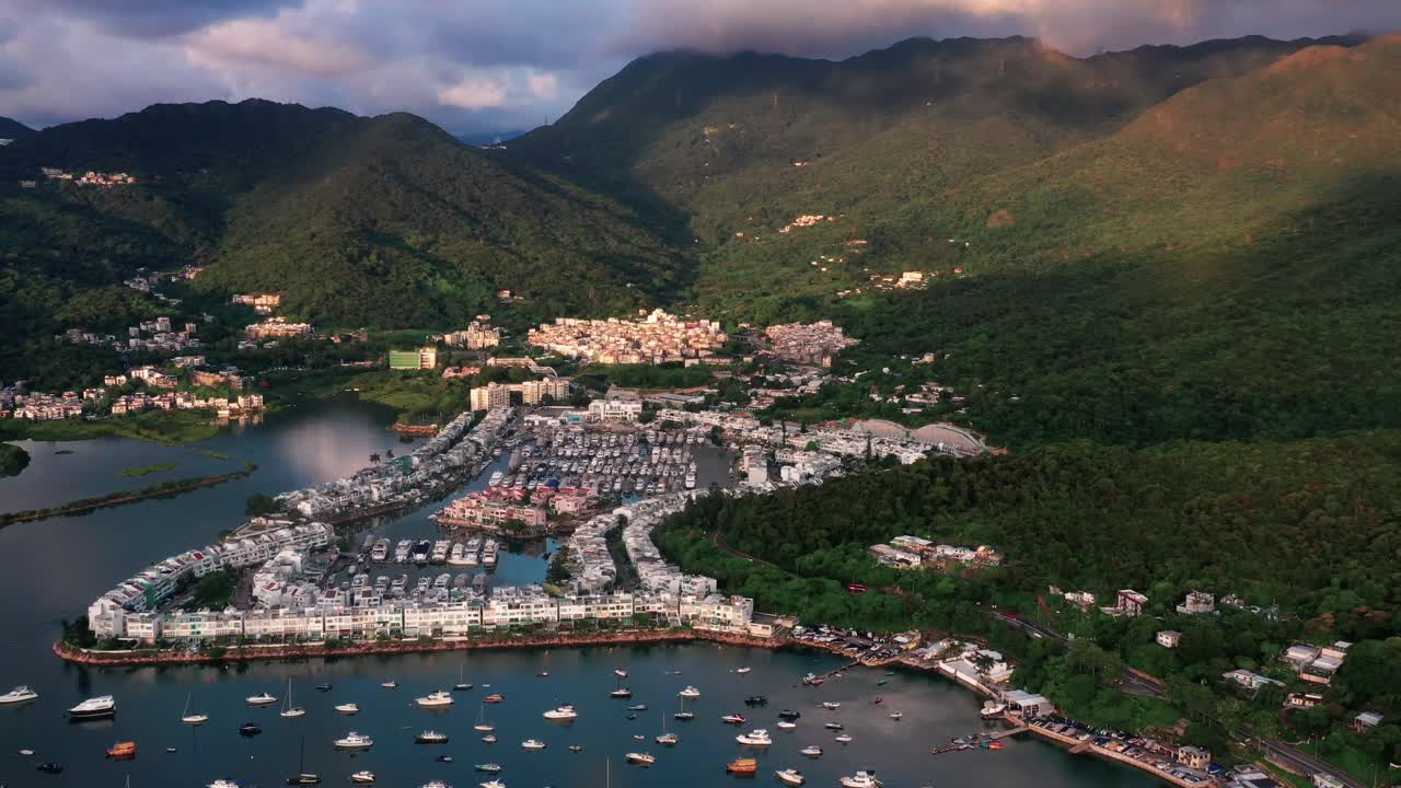 Aerial view of Hong Kong yacht club in Sai Kung. Boats are anchored in line at the yacht club surrounded by mountains