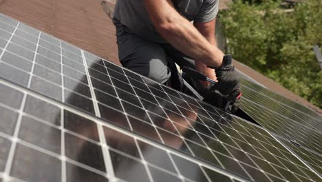 technician attaching solar panel to roof of customers house, sustainable energy