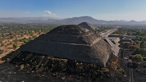 teotihuacan mexico aerial v4 low level fly around pyramid of the moon, capturing avenue of the dead leading to pyramid of the sun and beautiful mountainscape - shot with mavic 3 cine - december 2021