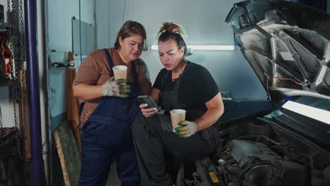 women mechanics discussing car repair
