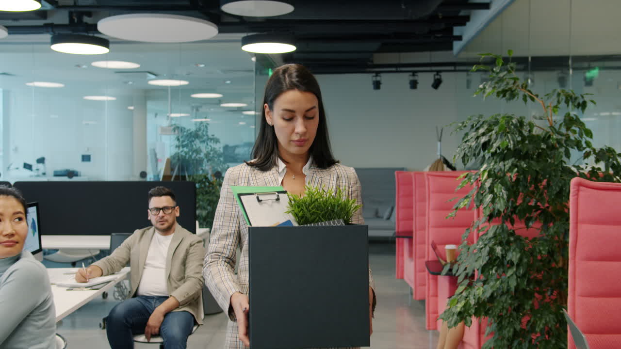 Woman Leaving the Office with a Box