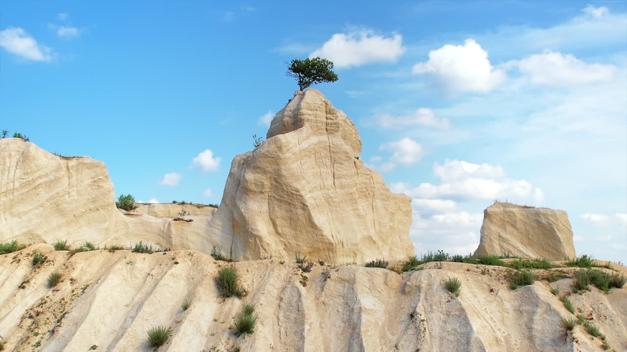 Aerial drone view of the Little Switzerland of Moldova located in Fetesti. Former limestone quarry with unusual landforms. lonely tree on top of a rock