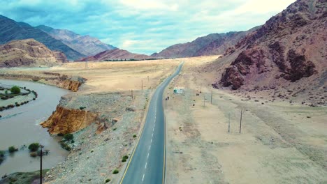 Aerial-drone-shot-of-a-road-through-Himalayan-Mountains-landscape-in-barren-cold-desert-of-Ladakh-India