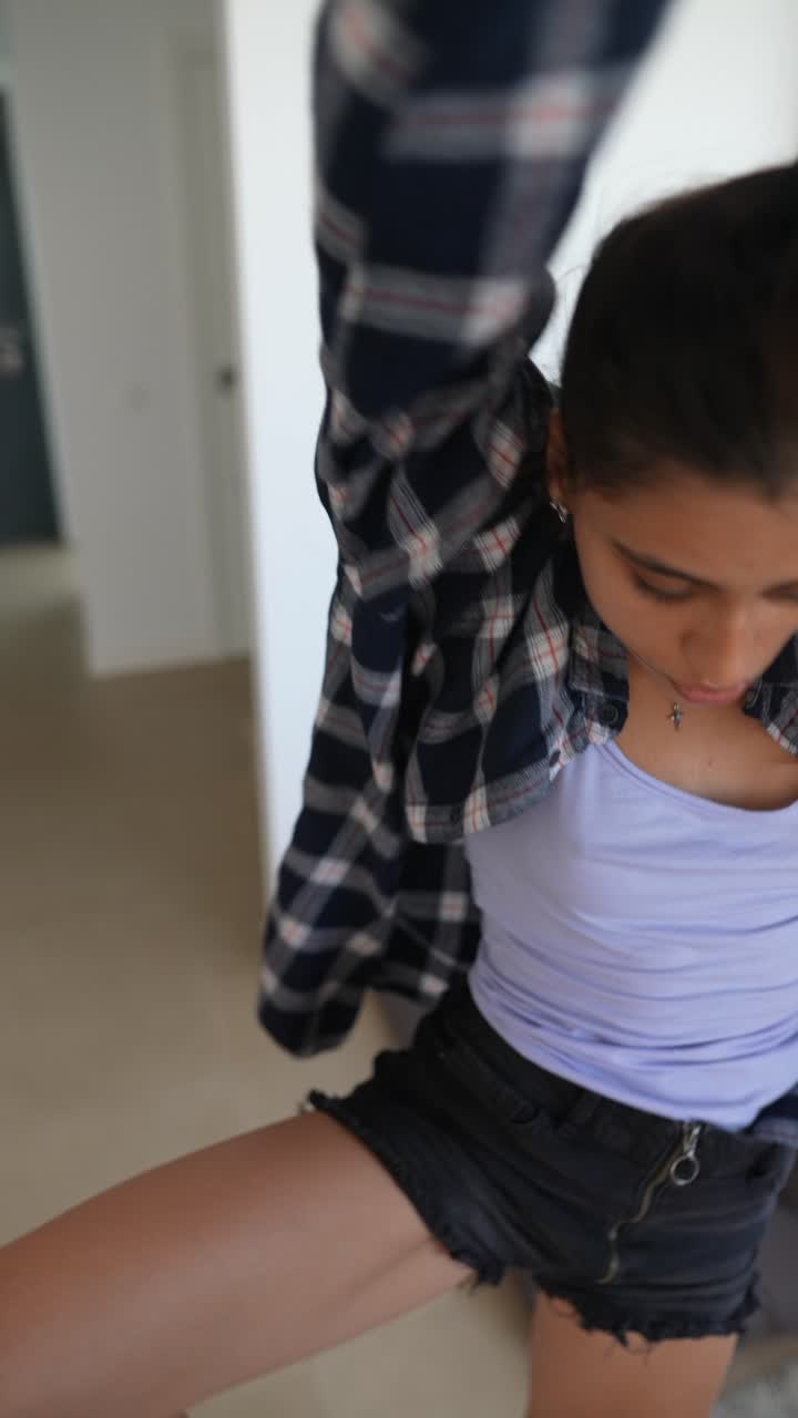 Teenage girl dancing in living room