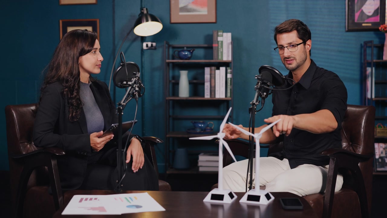 Professional Podcast Hosts Discussing Renewable Energy with Wind Turbine Models