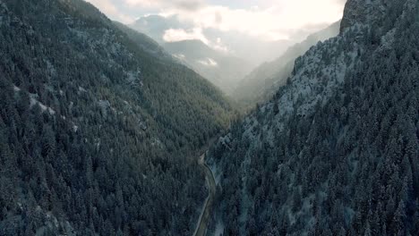 Road-Between-Steep-Mountain-Slopes-Covered-With-Pine-Trees-At-American-Fork-Canyon-In-Wasatch-Mountains-Of-Utah,-USA