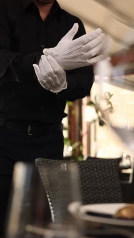 waiter in formal attire preparing to serve