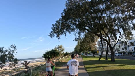 groups of people enjoying a seaside walk at sunset