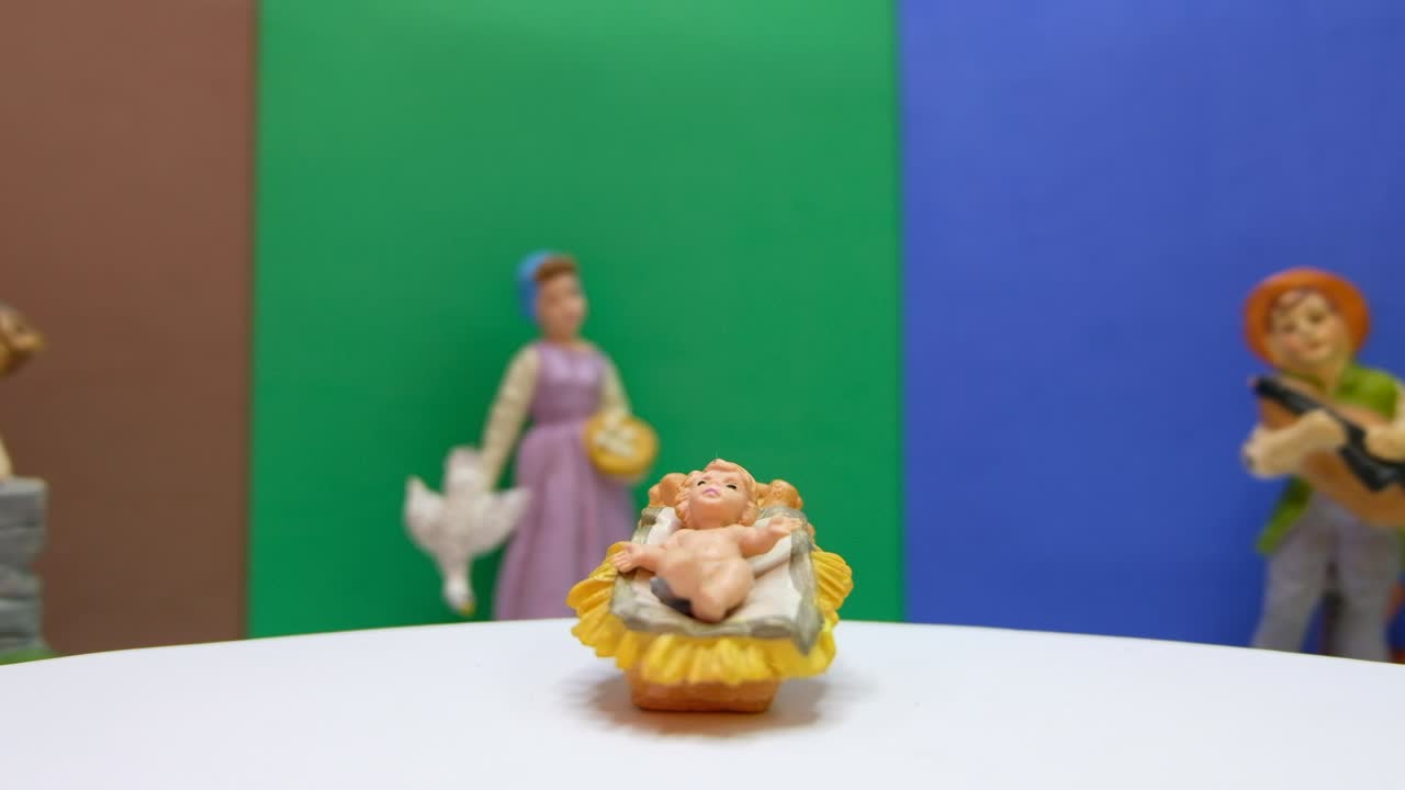 Gesù Cristo nella mangiatoia e sfondo colorato con persone